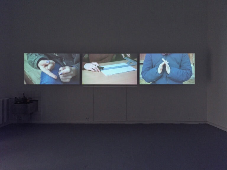 Foto: Ansicht eines abgedunkelten Raumes. An der Wand befindet sich ein projektiertes Bild.